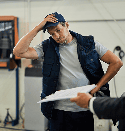 Worker and manager discussing what to do after a forklift accident