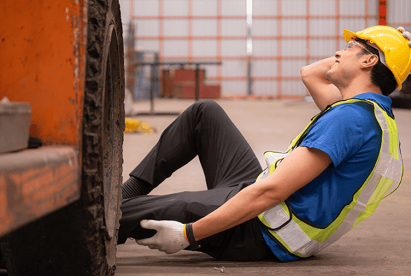 What is a forklift accident? What is a forklift accident? Injured warehouse worker holding his leg beside a forklift